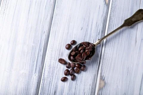 Silver spoon with coffee beans Stock Photos