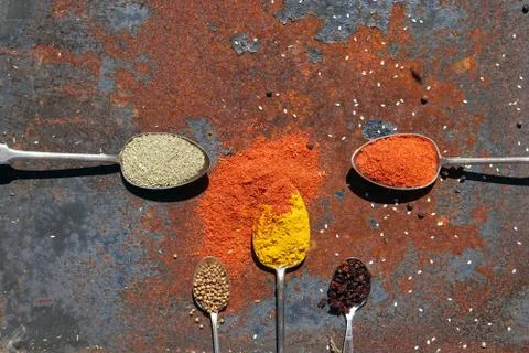 Silver spoon with various spices Stock Photos