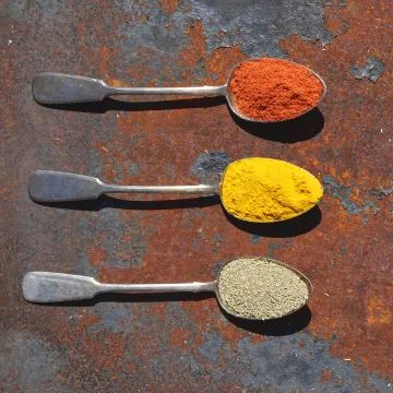 Silver spoon with various spices Stock Photos