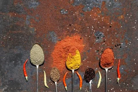 Silver spoon with various spices Stock Photos