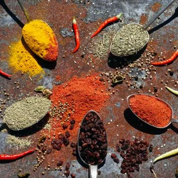 Silver spoon with various spices Stock Photos
