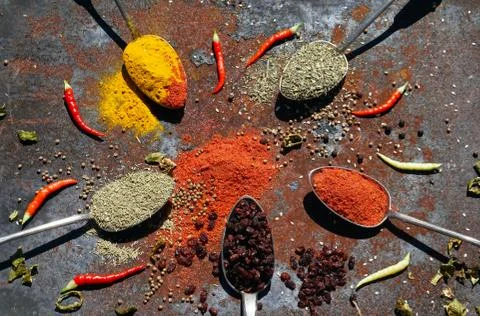 Silver spoon with various spices Stock Photos
