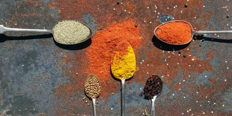 Silver spoon with various spices Stock Photos