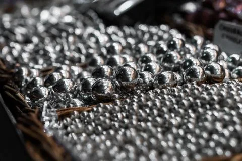 Silver sprinkle sugar candy for cake decoration in a wooden basket. Stock Photos
