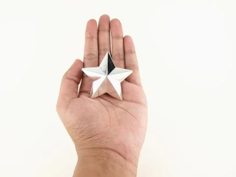 Silver star in hands Stock Photos