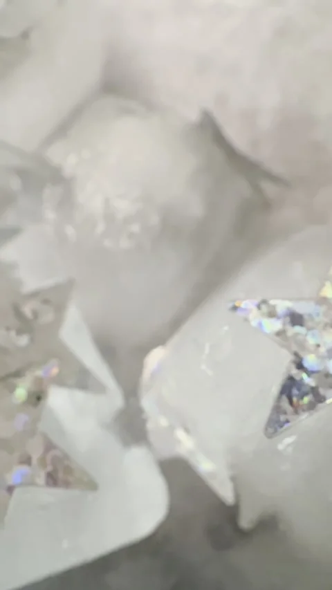 Silver Star Sequins Frozen Inside Ice Macro Abstract Background Video stock 333555339