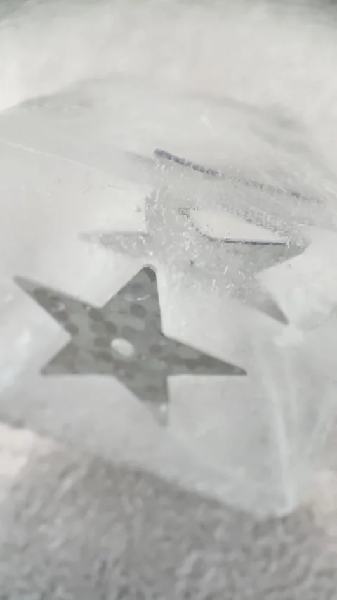 Silver Star Sequins Frozen Inside Ice Cubes Macro Abstract Video Stockbeeldmateriaal 333557640