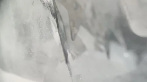 Silver Star Sequins Moving Between Ice Cubes Macro Abstract Video Stock Footage 333557645