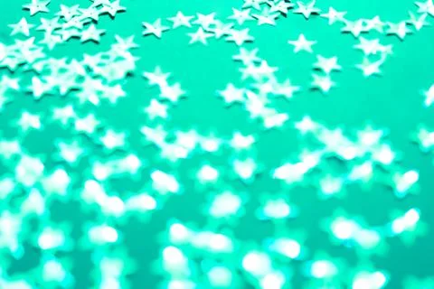 Silver star sparkles on mint backdrop. Festive Christmas concept. Stock Photos