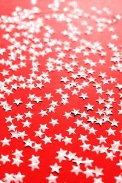 Silver star sparkles on red backdrop. Festive Christmas concept Stock-Fotos