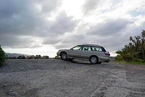 Silver Station Wagon on Gravel with Cloudy Sky Stock Photos