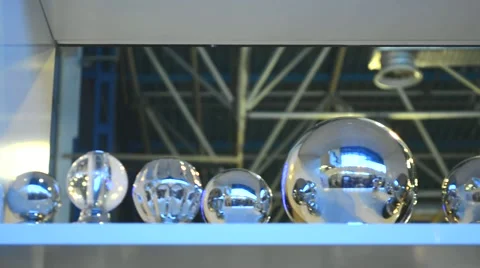 Silver Steel Balls of Different Sizes Placed in a Row on Shelf Stock Footage 64827005