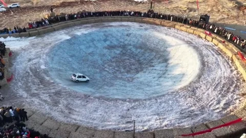 Silver SUV Driving on Steep Ice Walls of a Massive Circular Crater Video stock 331687790