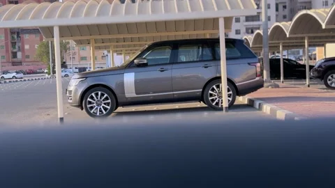 Silver SUV Parked Under Covered Carport in Residential Urban Parking Lot at Stock-Footage 332068852