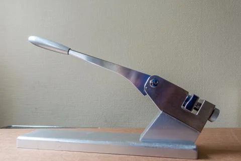 On a silver table stands a bending press for bending surgical metal plates Stock Photos