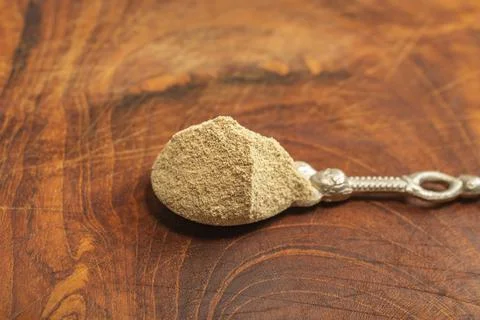 Silver tea spoon full of grounded white pepper Stock Photos