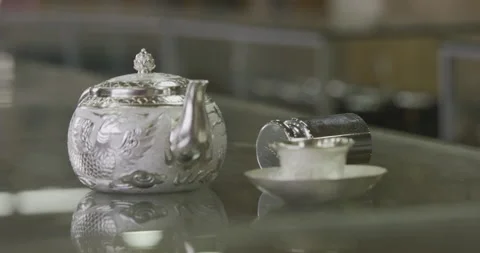 Silver Teapot on glass table Stock Footage 141363654
