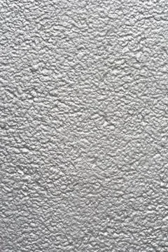 Silver textured metallic wall surface in a vertical full frame background Stock Photos