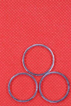 Silver three rings with red background Stock Photos