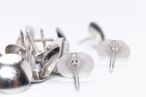 Silver Thumb Tacks on White Background, Close-Up View of Metal Push Pins, O.. 写真素材