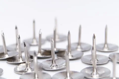 Silver Thumbtacks on White Background - Close-up of Sharp Metal Push Pins f.. Stock Photos