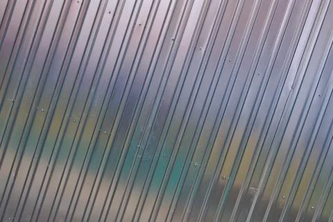 Silver tin iron wall with vertical and diagonal stripes from a metal profile  Stock Photos