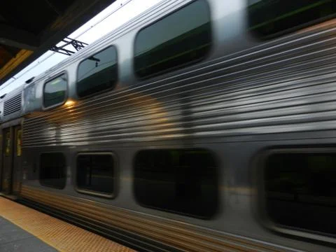 Silver train arriving to station Stock Photos