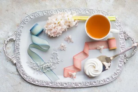 Silver tray with a cup of tea, marshmallows and silver spoon Stock Photos