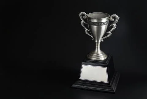 Silver trophy over black background. Winning awards with copy space for tex.. Foto stock