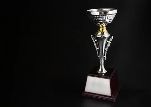 Silver trophy over black background. Winning awards with copy space for tex.. Foto stock