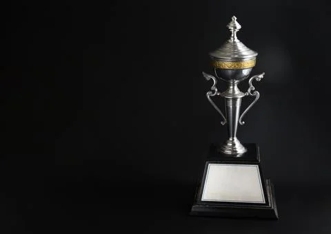 Silver trophy over black background. Winning awards with copy space for tex.. Foto stock
