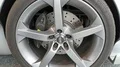 Silver TVR Sagaris exhibition automobile wheel in showroom 4k 4k or 4k+ Resolution