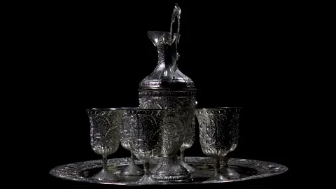 A silver ware set, rotating on an automatic display stand Stock Footage 263042821