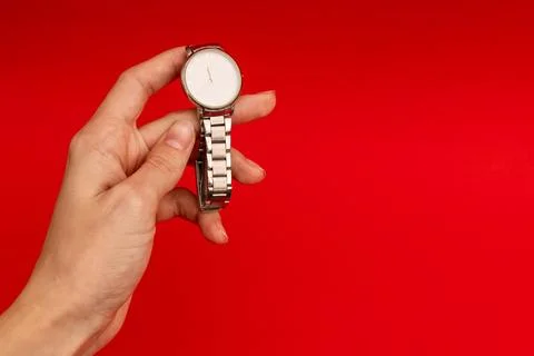 Silver watch on a bright red background Stock Photos