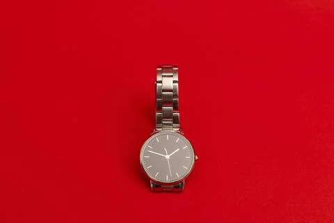 Silver watch on a bright red background Stock Photos