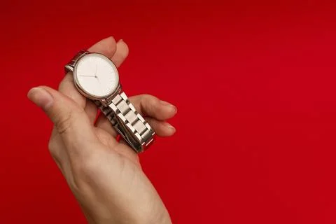 Silver watch on a bright red background Stock Photos