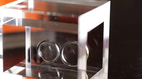 Silver Wedding Rings in the glass box macro closeup shoot diamon Jewellery Stock Footage 93720144