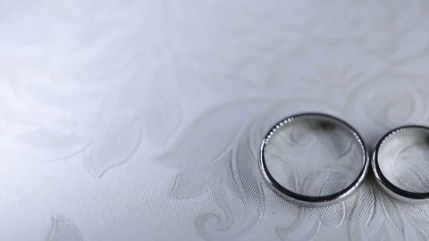 Silver Wedding Rings on the table macro closeup shoot diamon Jewellery Stock Footage 93721888