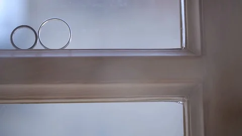 Silver Wedding Rings on the window with light flares macro closeup shoot diamon Stock-Footage 93720703