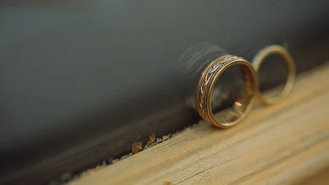 Silver Wedding Rings on the window with sunlights light flares macro closeup Stock Footage 114486120