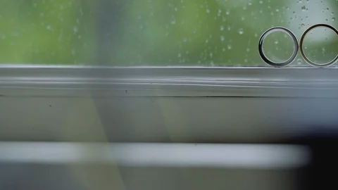 Silver Wedding Rings on the window with sunlights light flares macro closeup Stock Footage 114488307