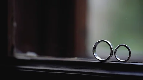Silver Wedding Rings on the window with sunlights light flares macro closeup Stock Footage 114489328