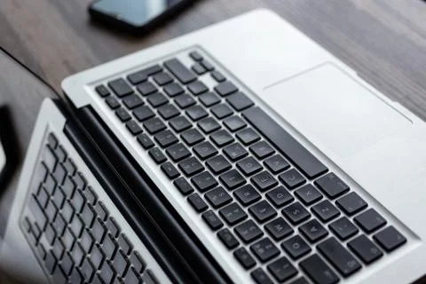 Silver white laptop computer keyboard from above Stock Photos