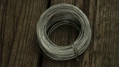 Silver Wire Coil Being Dragged to the Left Stock Footage 73437076