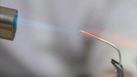 The silver wire is heated and burnt by jewelry master Stock Footage