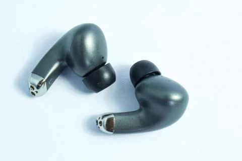 Silver wireless headset or earphone is called TWS Stock Photos