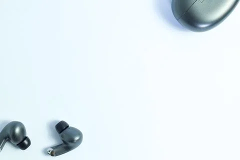 Silver wireless headset or earphone is called TWS Stock Photos