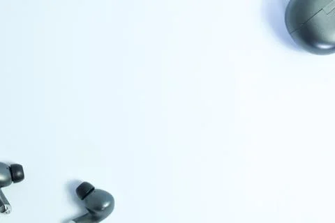 Silver wireless headset or earphone is called TWS Stock Photos