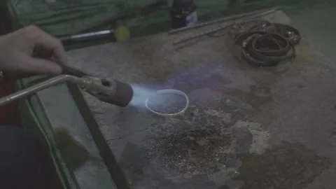 Silversmith Forging Silver Bracelet with Torch Stock-Footage 343556307