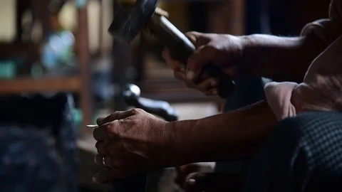 Silversmith hitting the piece of silver  with hammer Stock Footage 71186456